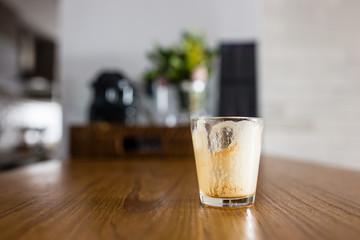 empty dirty espresso coffee cup on kitchen counter with interesting perspective, with cup in focus and blurred background