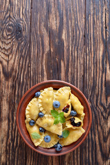 Fototapeta premium blueberry dumplings, pierogi, vareniki in a bowl
