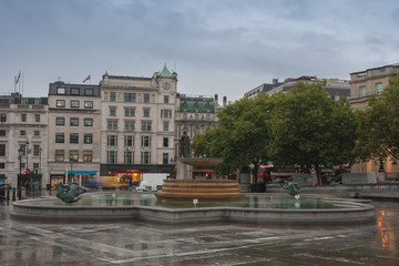 The fountain on Trafalgar square in rainy early morning time  in London, United Kingdom