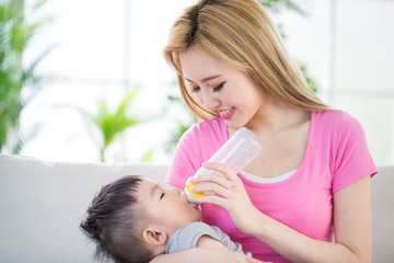 Obraz na płótnie Canvas mom feeding milk to son