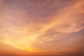 Sky blue and orange light of the sun through the clouds in the sky