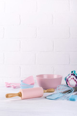Baking background with kitchen tools: rolling pin, wooden spoons, whisk, sieve, bakeware and shape...