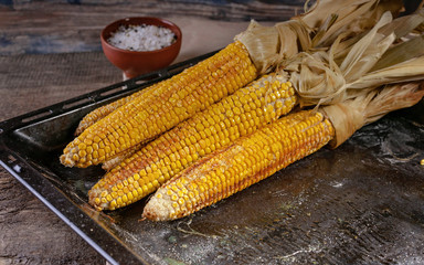 Boiled corn on the cob on a rustic table. Close-up.