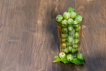 Fresh harvest of gooseberries in a glass