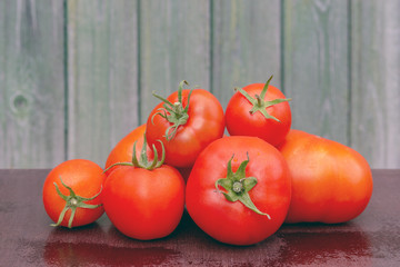 Bunch of tomatoes on the background of a wooden facade