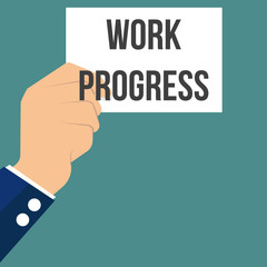 Man showing paper WORK PROGRESS text