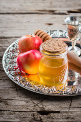 Honey Jar and Apples on beautiful tray on wooden table background. Jewish Holiday Rosh Hashanah Concept