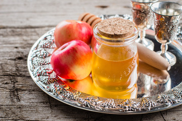 Honey Jar and Apples on beautiful tray on wooden table background. Jewish Holiday Rosh Hashanah Concept