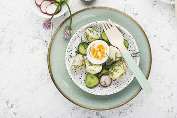 Potato salad farmer market with fresh vegetables cucumber, radish and organic eggs with dill and chives onions. Top View.