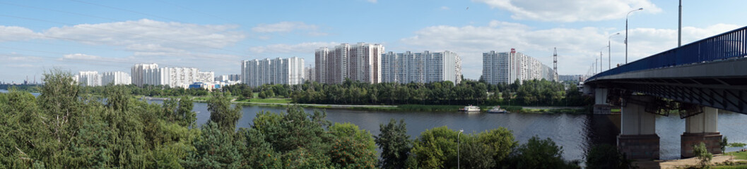 Fototapeta na wymiar MOSCOW, RUSSIA - CIRCA JULY 2018 Apartment buildings, Moscow river and bridge in Brateevo district