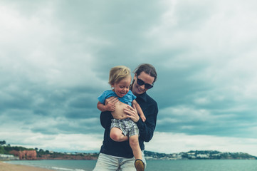 Young woman on beach with toddler