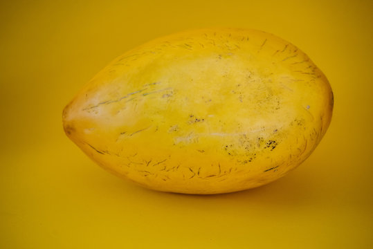 Yellow canary melon on the yellow background