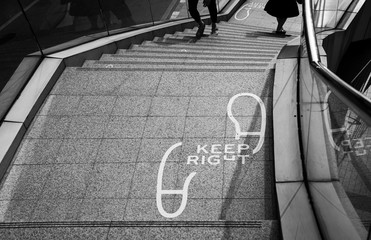 "Keep Right" word and sign on the stairs of fly over bridge, black and white