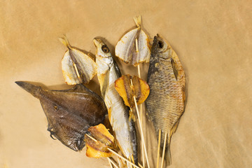 Sun dried fish. Fish on the brown craft paper. Bleak.