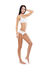 Fototapeta premium Fit and sporty girl in white swimsuit. Sport, fitness, diet, weight loss and healthcare concept.