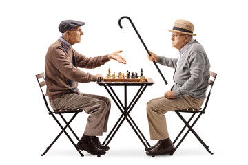 Seniors playing a game of chess and arguing