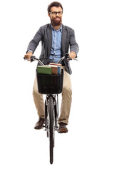 Young man riding a bicycle towards the camera