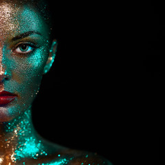 Portrait of Beautiful Woman with Sparkles on her Face. Girl with Art Make-Up in Color Light. Fashion Model with Colorful Makeup