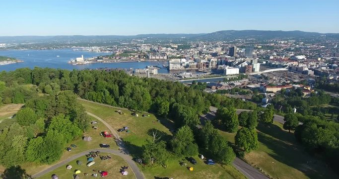 Flying above the Ekeberg a neighborhood of Oslo with great view at cityscape. Urban campsite on hill. Norway