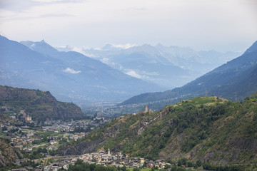 Fototapeta na wymiar valley with city of sierre in swiss wallis with high snow capped mountains