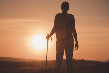 Silhouette hiker woman tracking with backpack