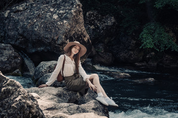woman traveler with backpack and hat walking