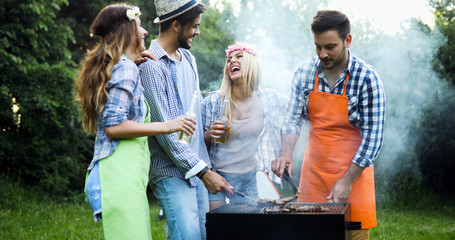 Friends having a barbecue party in nature