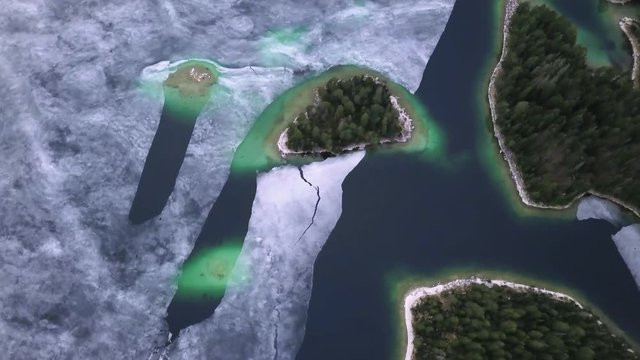 Eibsee Lake, Germany, Beautiful aerial footage. Broken blue ice, green ice.