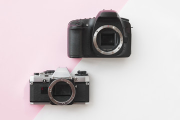 Concept - Digital vs. Analog SLR Camera on Pink Background