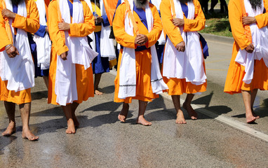 Sikh soldiers walk barefoot during a religious event