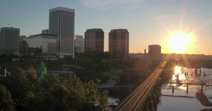 Drone Sunrise Over City by Railroad Tracks