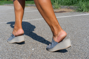 close up details legs wearing wedges sandal shoes, footwear in walking pose