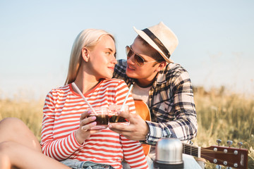 happy couple in love at a picnic. two young people have a rest on the nature, have fun. Summer holidays