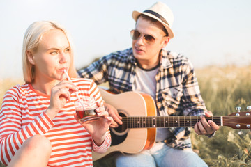 happy couple in love at a picnic. two young people have a rest on the nature, have fun. Summer holidays