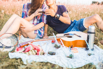 happy couple in love at a picnic. two young people have a rest on the nature, have fun. Summer holidays