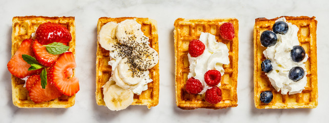 Traditional belgian waffles with whipped cream and fresh fruits  - obrazy, fototapety, plakaty