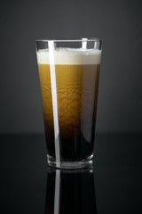 Draft Nitrogen Fresh and Creamy Black Stout Beer Pint over Black Background