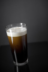 Draft Nitrogen Fresh and Creamy Black Stout Beer Pint over Black Background