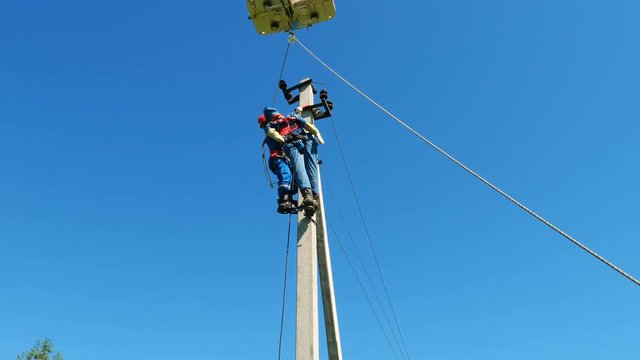 electrician removes dummy victim from post at training
