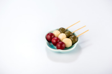 Japanese Dango dessert with 3 different color in pink(red), white, and green, recipe, hanami Dango, tsukimi Dango, copy space.