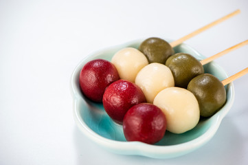 Japanese Dango dessert with 3 different color in pink(red), white, and green, recipe, hanami Dango, tsukimi Dango, copy space.