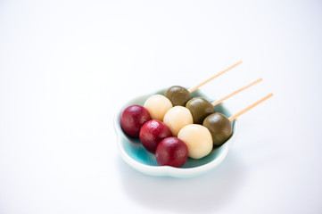Japanese Dango dessert with 3 different color in pink(red), white, and green, recipe, hanami Dango, tsukimi Dango, copy space.
