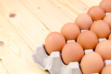 Brown eggs in carton box.