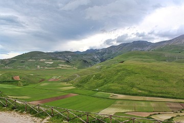 View of the plateau of Castelluccio di Norcia (Umbria, Italy) from the village. In the valley the fields of lentils.