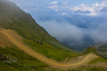 Fototapeta premium Mountain road high in clouds in the mountains of Sochi, Russia, August 22, 2017