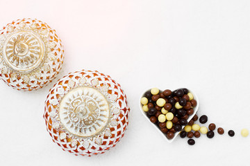 Eid Mubarak greeting with Eid Al Adha sacrifice festival, Islamic Arabic candle and sweet chocolate sugars