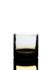 Empty Golden Whisky Glass and Reflection Isolated on White