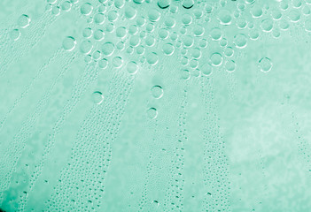 Water drops at gradient background. Glass covered with condensation