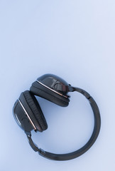 Wireless headphones are isolated on a blue background, the top view. Musical concept. Copyspace