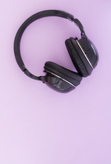 Wireless headphones are isolated on a pink background, the top view. Musical concept. Copyspace